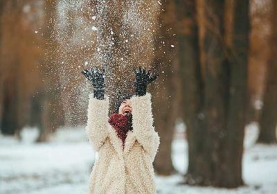 young-beautiful-woman-throws-snow-head