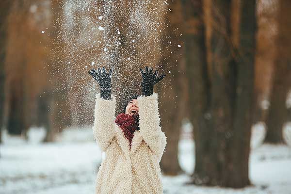 young-beautiful-woman-throws-snow-head
