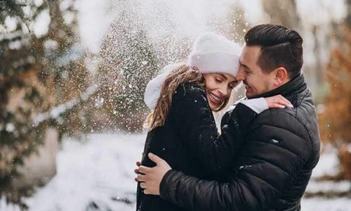 young-couple-winter-snow-falling-from-tree